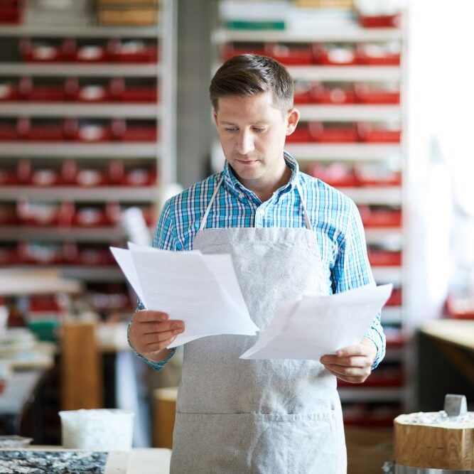 Small businessperson looking at paperwork